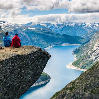 couple admiring the view trolltunga norway