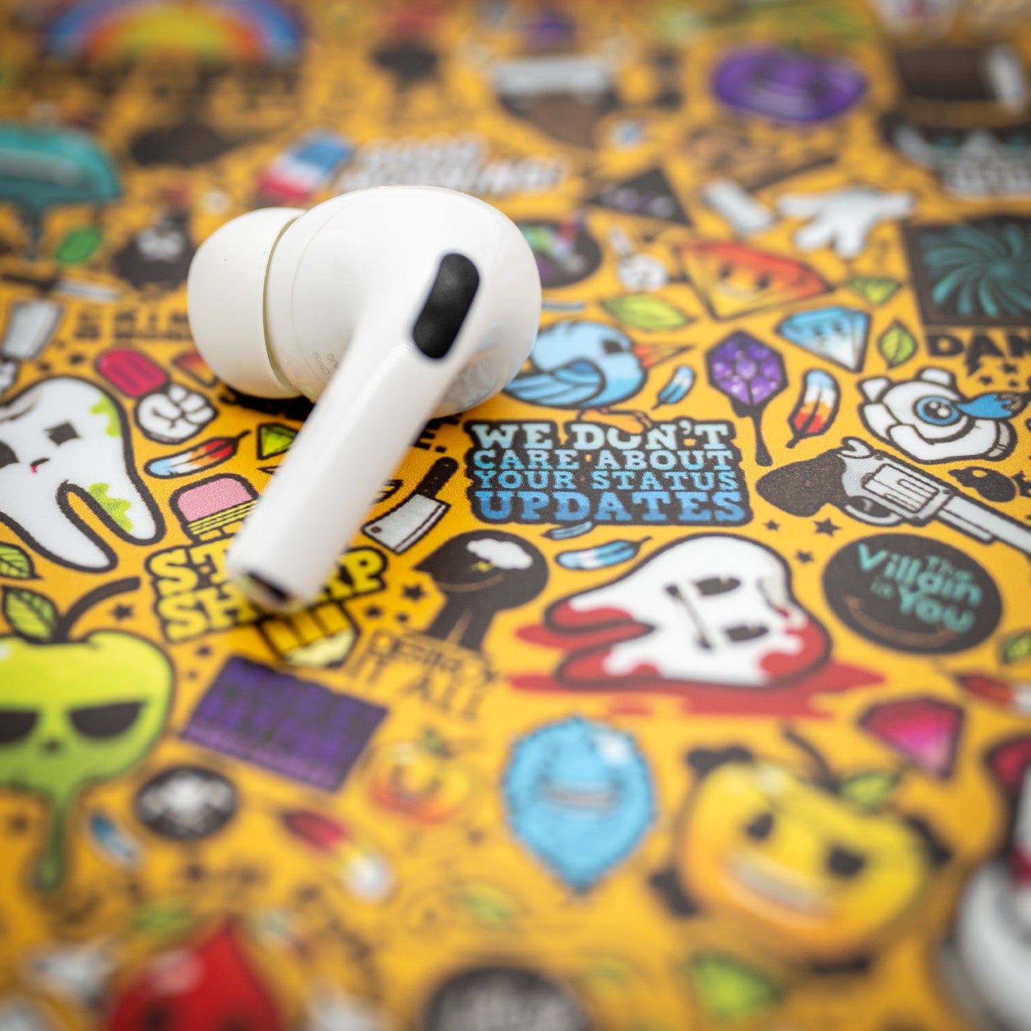 Photograph of an Airpod sitting on top of a skin.