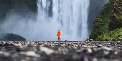 person under skogafoss waterfall iceland 1?400x200;crop