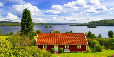 traditional red cottage house at the lake in sweden